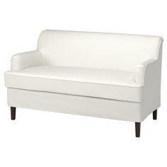 a white couch sitting on top of a wooden floor