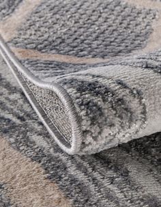 a close up view of a gray and white rug