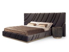 a bed that is made up and has pillows on the headboard, along with two nightstands