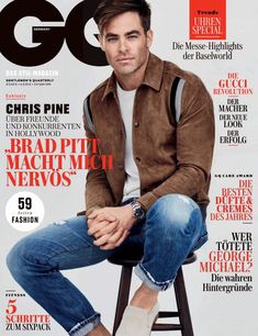 a man sitting on top of a stool in front of a magazine cover