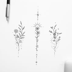 three flowers are drawn on the wall next to a pen