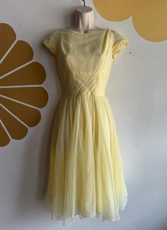 Vintage 1950s Lorrie Deb San Francisco pastel yellow cap sleeve chiffon swing dress. Great vintage condition. Small spot underneath the chiffon layers on skirt. See last two photos. Unnoticeable when worn but reflected in price. Spot clean the area to remove.  No size listed on tag. See measurements below to ensure fit. Best fits XS/S. Length laid flat from shoulder to base: 43" Chest across laid flat, pit to pit: 16.5" Waist across laid flat: 12" Hips across laid flat: free hip  Sleeve length f Vintage Fitted Chiffon Dresses, Fitted Vintage Chiffon Dresses, Yellow 1950s Style Dress For Vintage Fashion, 1950s Style Yellow Vintage Dress For Spring, 1950s Style Vintage Yellow Dress For Spring, 1950s Style Yellow Dress For Vintage Fashion, Yellow Vintage Dress, 1950s Style For Spring, Yellow Vintage Dress 1950s Style For Spring, Yellow Vintage Dress For Vintage Events