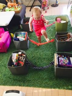 a toddler playing with toys on the floor in a play room at a child's birthday party