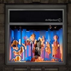 a window display with mannequins in front of it