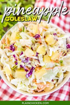 a white bowl filled with coleslaw salad on top of a red and white checkered table cloth