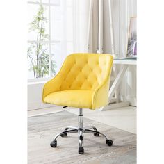 a yellow office chair sitting on top of a hard wood floor next to a window