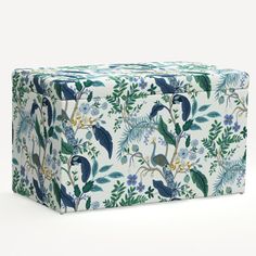 a blue and white floral box with birds on it