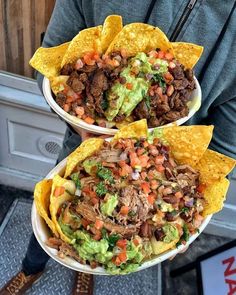 two white bowls filled with tacos and meat