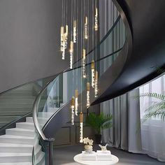 a spiral staircase with chandelier hanging from it