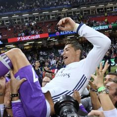 a soccer player is being carried off the field by fans