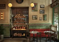 the interior of a restaurant with tables, chairs and food on display in front of them