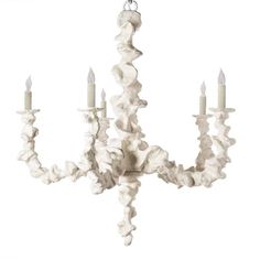 a white chandelier with five lights hanging from it's center, in front of a white background