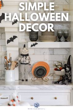 a white kitchen counter topped with halloween decorations