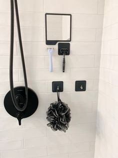 there is a shower head and soap dispenser on the wall