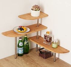 three tiered wooden shelves with drinks and snacks on the top one shelf is empty