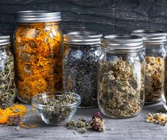 several jars filled with different types of herbs