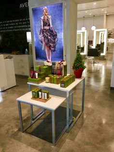 there is a display in the store for women's clothing and accessories on tables