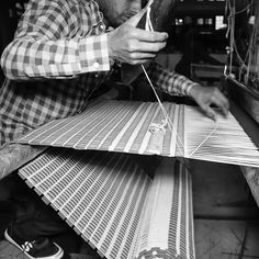 a man is working on some type of weaving machine