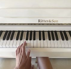 a person is playing the piano with their hand on it's finger and fingers resting against the edge of the keyboard