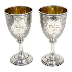 two silver goblets sitting side by side