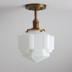 a white light hanging from a ceiling fixture