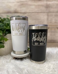 two personalized tumblers sitting next to each other on a white furnishing