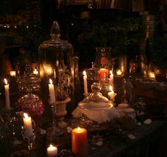 a table topped with lots of lit candles