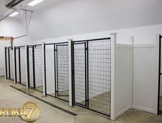 a row of gates in the middle of a room with white walls and doors on each side