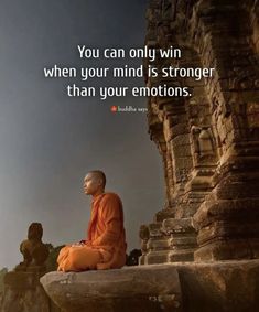 a man sitting on top of a stone wall next to a statue with a buddha quote