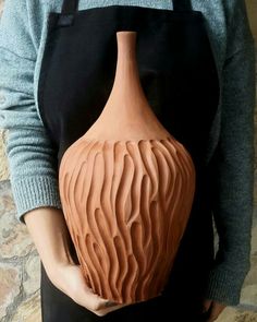 a person is holding a vase in their hands and it looks like they are making waves