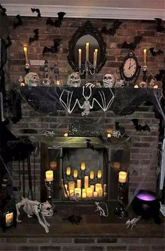 a fireplace decorated for halloween with candles and decorations