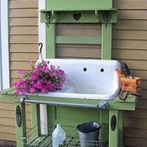 a sink and some flowers in front of a house