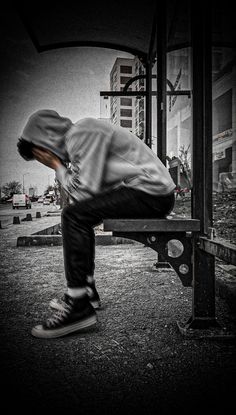 a man is bent over on a bench