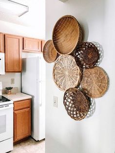 some baskets are hanging on the wall in a kitchen