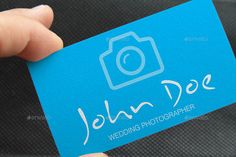 a person holding up a blue business card