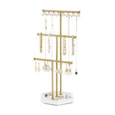 a gold jewelry rack with earrings hanging from it