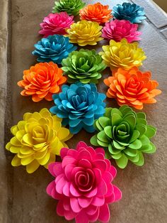 colorful paper flowers laid out on a table