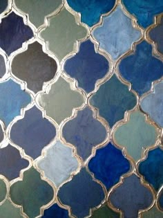 a close up view of a blue and green mosaic tile