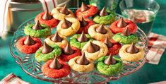 a glass platter filled with cookies and candy