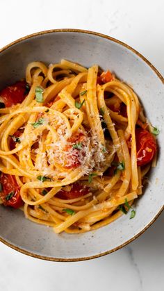 pasta with tomatoes and parmesan cheese in a bowl