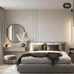 a bedroom with a bed, mirror and table in the corner next to a window