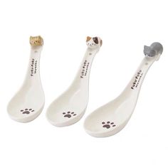 three toothbrushes with different designs on them, one has a cat's paw and the other has a dog's head