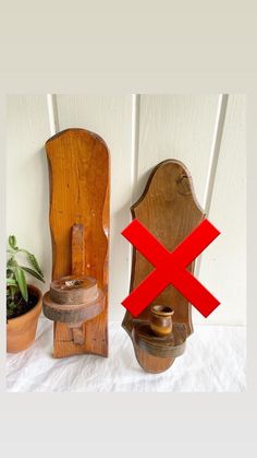 an old wooden clock with a red cross mark on the front and back of it