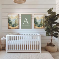 a baby's room with two paintings on the wall and a white crib