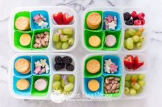 four plastic trays filled with different types of food on top of a marble table