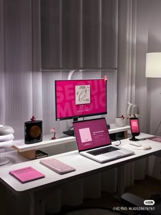 a laptop computer sitting on top of a desk next to a phone and other items