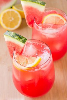 two glasses filled with watermelon lemonade and cucumber garnish