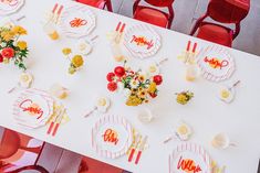 an overhead view of a table set with flowers and place settings for people to eat