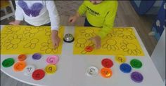 two children are playing with numbers on a table