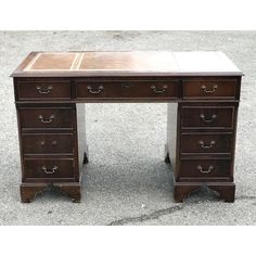 an antique desk with drawers on the top